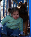 Squirrel, Fawn Cane Corso pup watching over her little girl, Hope.